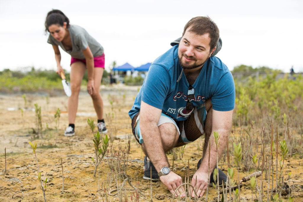 Alex Constantakis, member of the Rotaract Club of East Nassau. Rotarians and Rotaractors plant mangrove trees at Bonefish Pond National Park in Nassau as part of a project organized by the Rotary Club of East Nassau, New Providence, Bahamas, and the Bahamas National Trust. 16 December 2017. Restoring the mangrove ecosystem will help protect the coast against hurricanes.